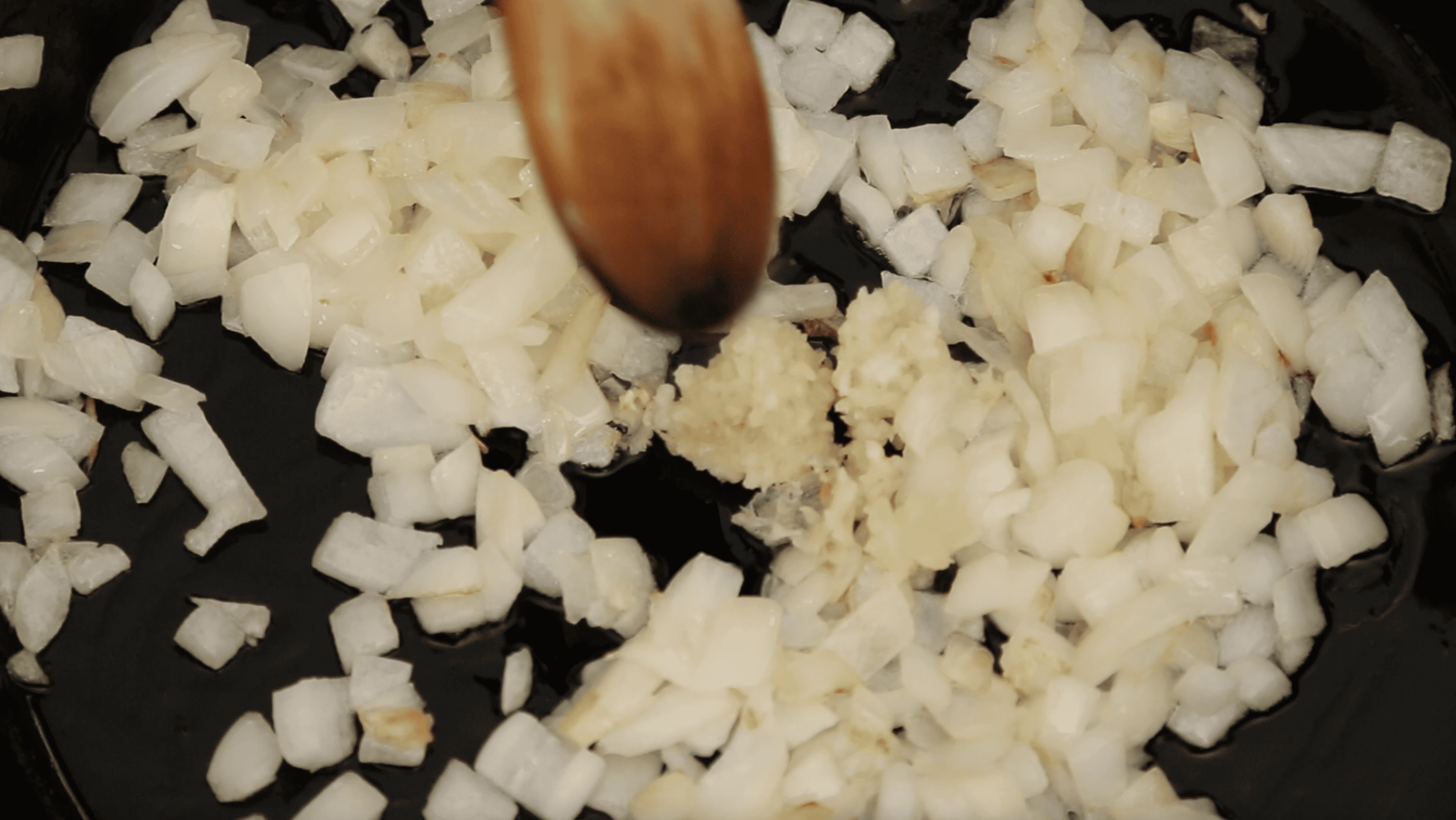 sautéing onions in a pan