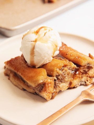 banana tarte tatin on a plate with vanilla ice cream scoop and caramel sauce
