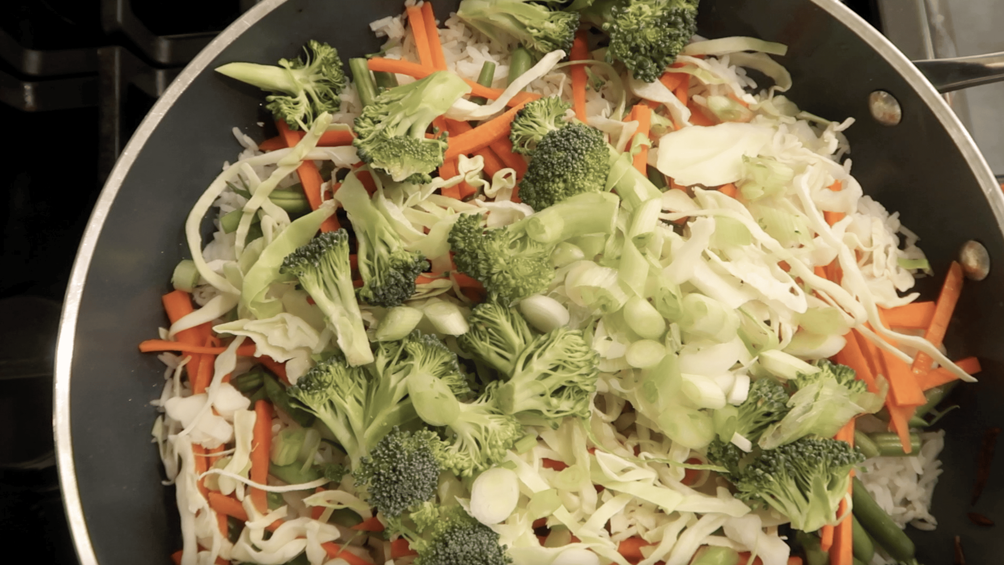 overhead of a pan with rice and vegetables layered in it