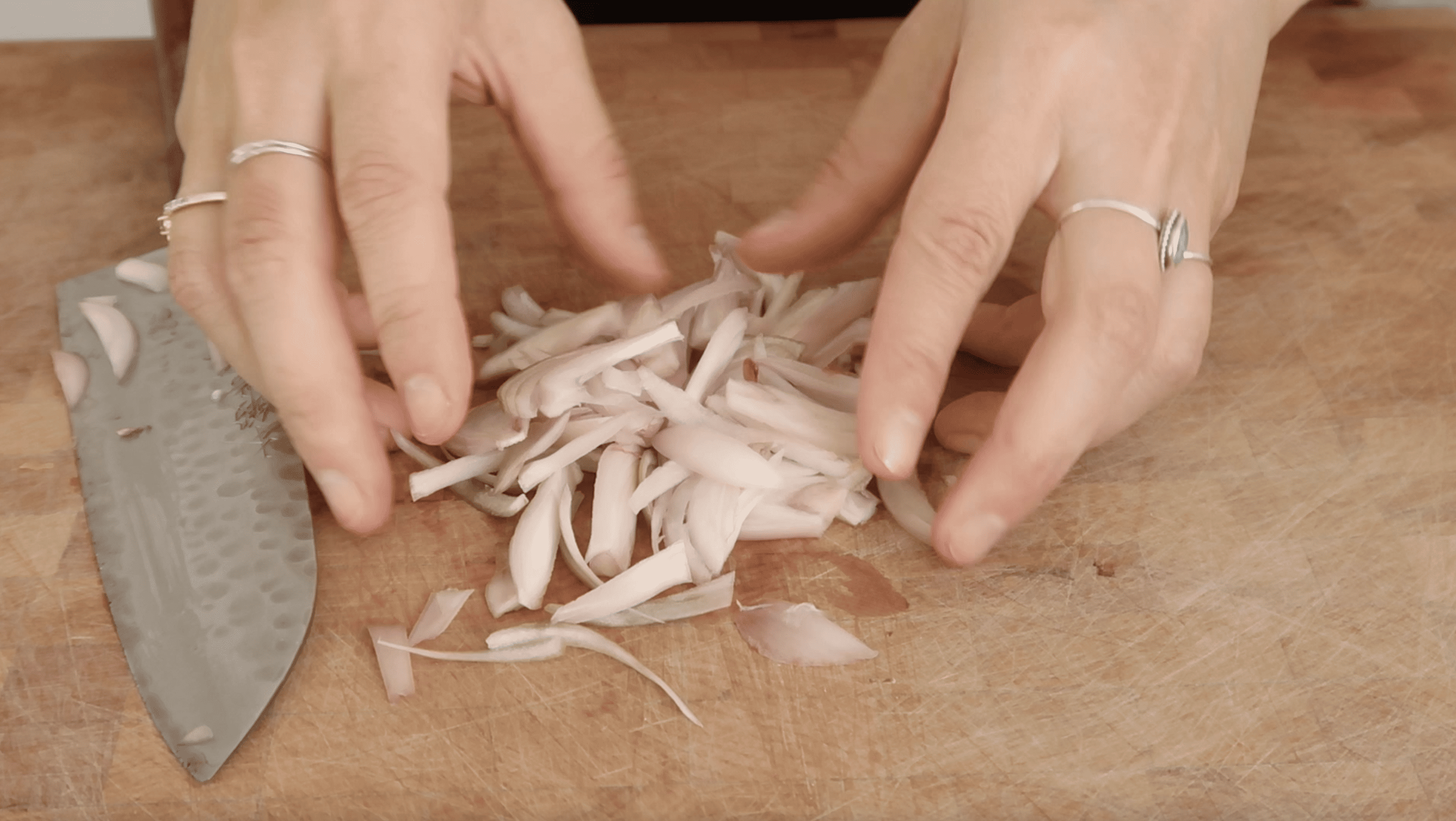 sliced shallot on a wooden cutting board